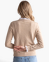Beach Rose Co. beige knit sweater with white scalloped lace trim on the neckline and cuffs, viewed from the back.