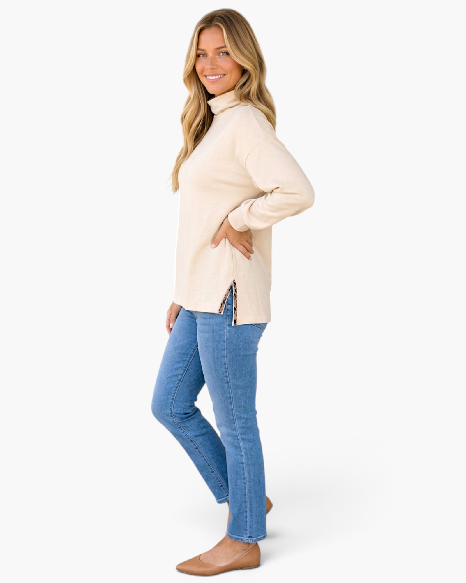 Beach Rose Co. beige long sleeve high neck top with leopard print split hem detail worn by a smiling blonde woman.