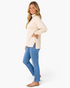 Beach Rose Co. beige long sleeve high neck top with leopard print split hem detail worn by a smiling blonde woman.