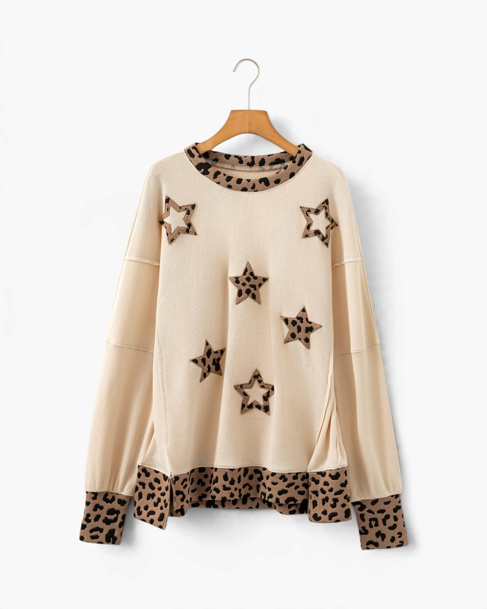 Beach Rose Co. beige long-sleeve top featuring leopard-print star appliqués, contrast trim, and a relaxed fit.