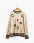 Beach Rose Co. beige long-sleeve top featuring leopard-print star appliqués, contrast trim, and a relaxed fit.