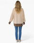 Beach Rose Co. beige long-sleeve top with leopard-print cuffs and hem, worn by a blonde woman with jeans, back view.