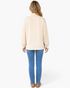 Beach Rose Co. beige long sleeve top with high neck and leopard print split hem detail worn with blue jeans