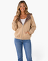 Beach Rose Co. beige zip-up hoodie with brown and ivory polka dot hood lining and front trim, worn by a smiling model.