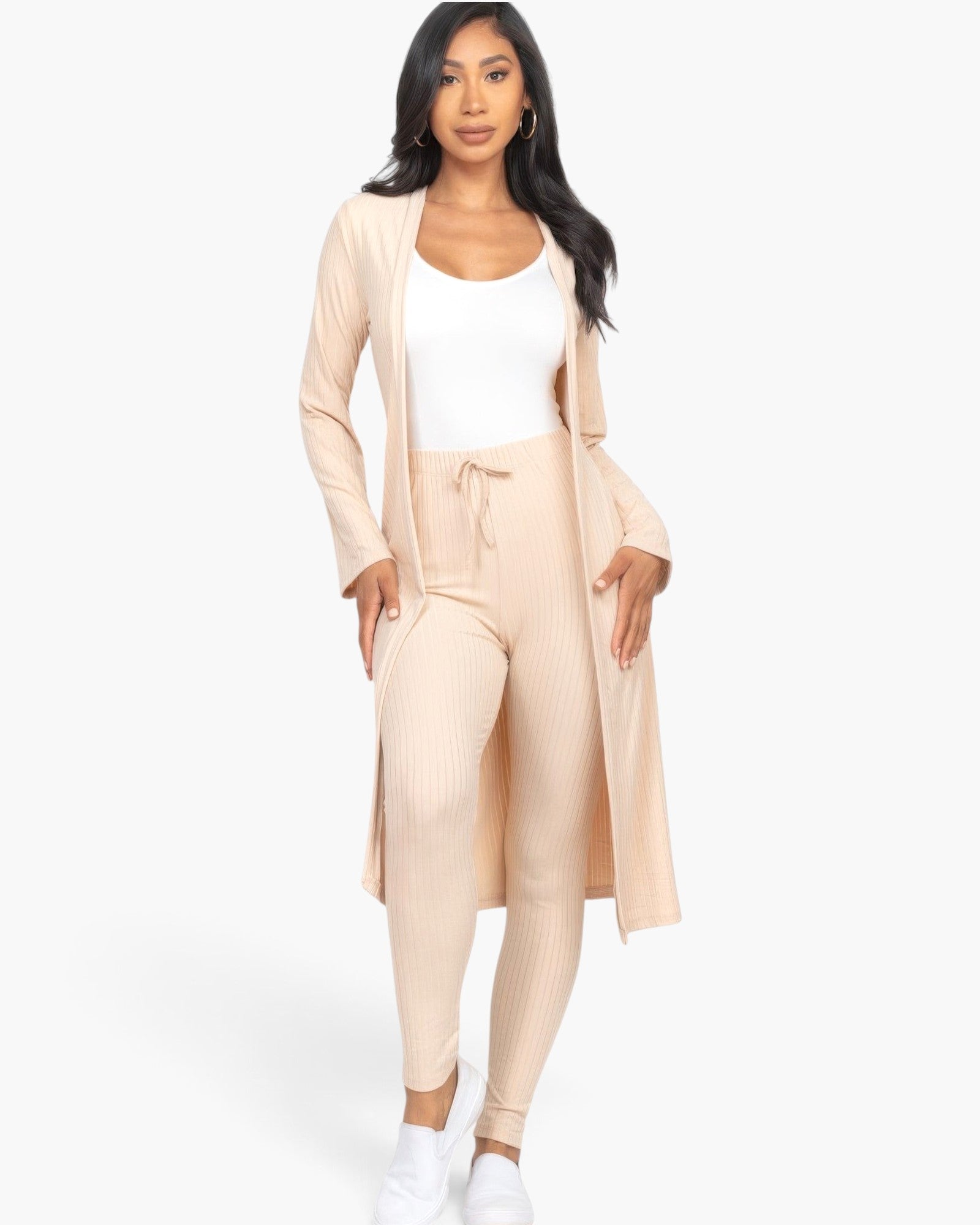 Beach Rose Co. model wearing a beige ribbed long cardigan and matching leggings set with a white tank top.