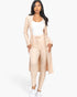 Beach Rose Co. model wearing a beige ribbed long cardigan and matching leggings set with a white tank top.
