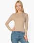 Beach Rose Co. beige long-sleeve top with a ribbed texture, crew neckline, and fitted silhouette on a blonde model.