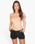 Beach Rose Co. model wearing a beige ribbed long-sleeve crew-neck top with a fitted silhouette and black shorts.