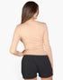 Beach Rose Co. beige ribbed long-sleeve crew-neck top worn by a woman, back view showing fitted silhouette