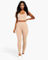 Beach Rose Co. model wearing a beige ribbed crop top and high-waisted leggings set with a flattering fit.
