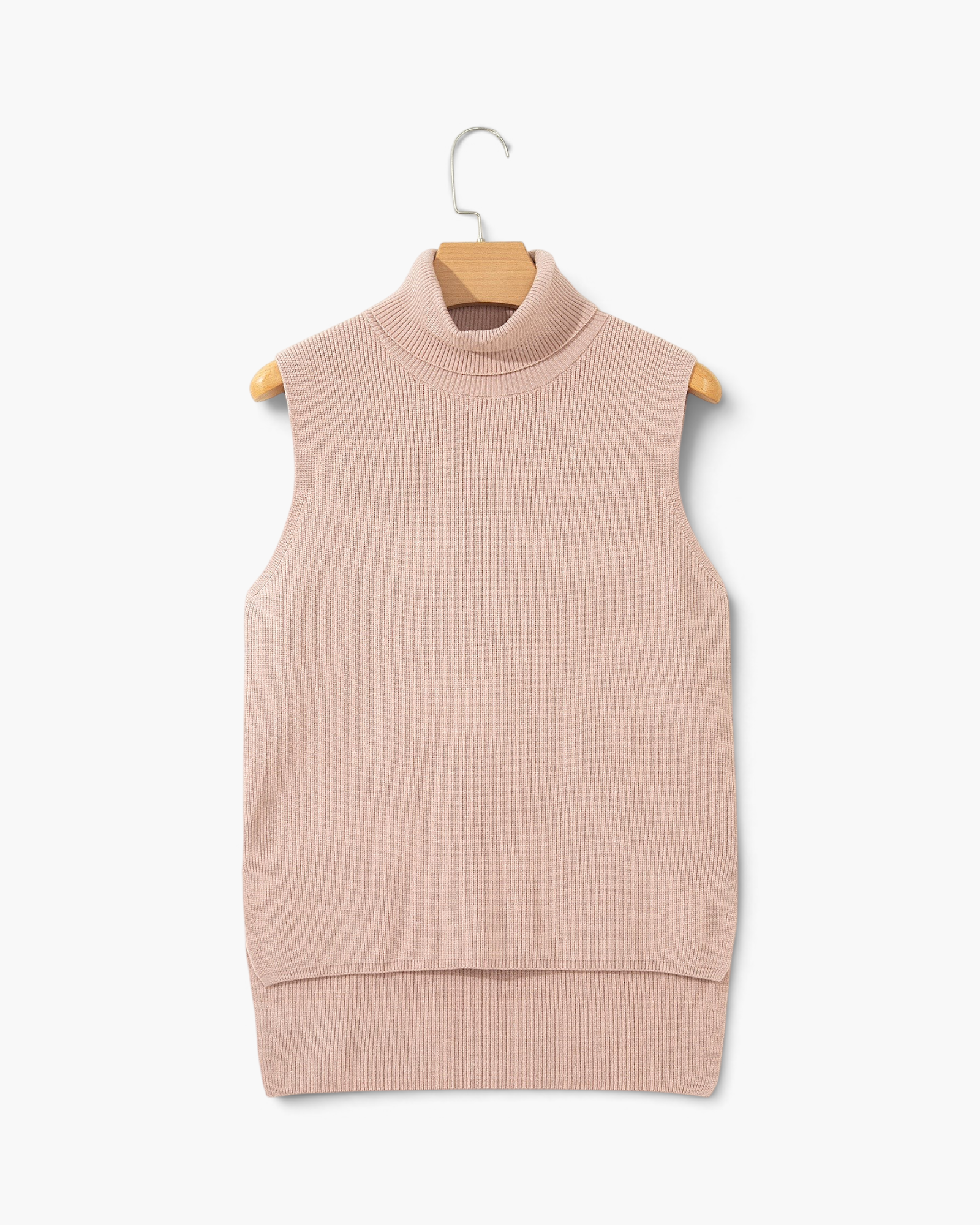 Beach Rose Co. beige sleeveless turtleneck sweater in a ribbed knit texture with a high-low hem on a wooden hanger.