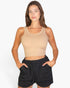 Beach Rose Co. model wearing a form-fitting beige ribbed tank top with a scoop neckline against a white background.