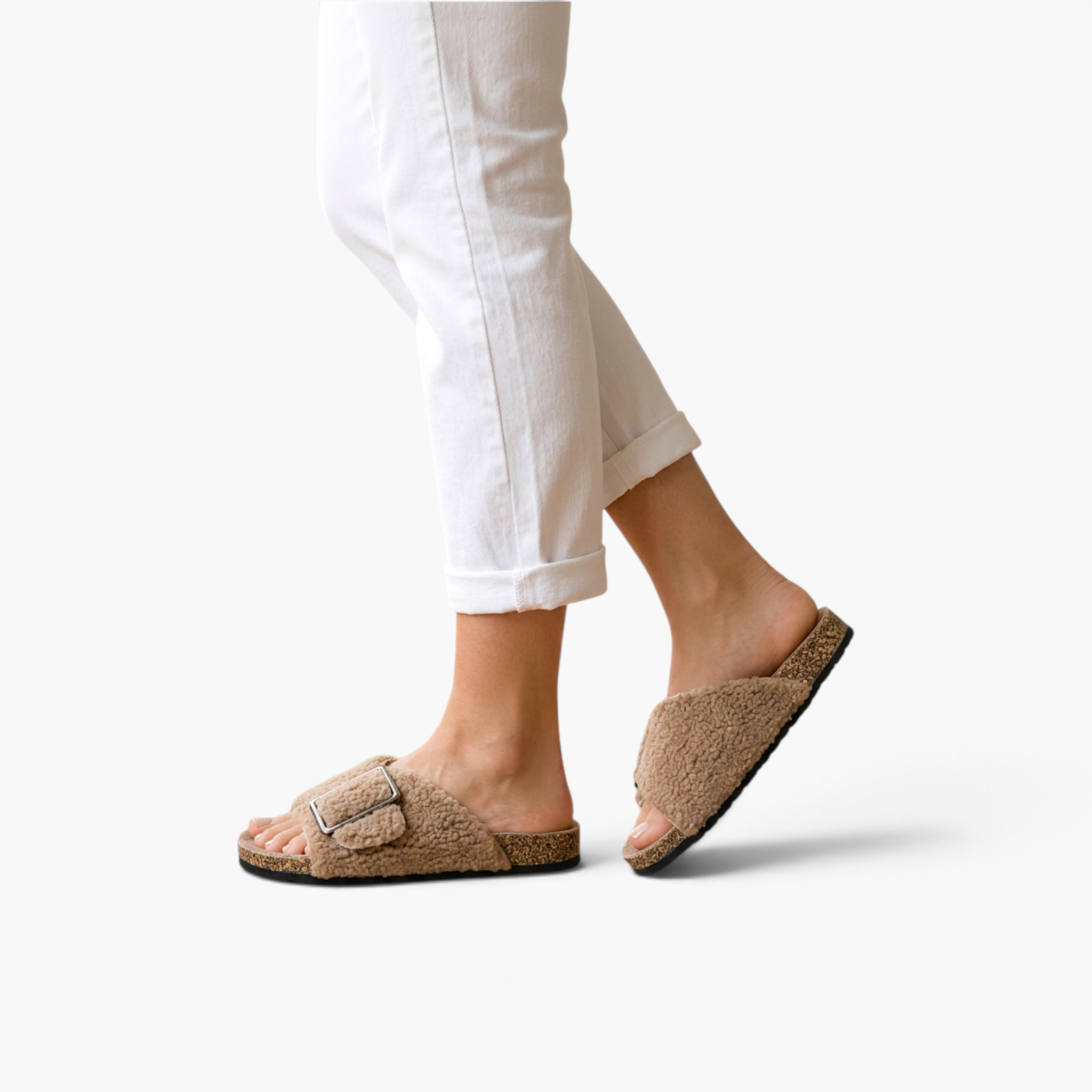 Beach Rose Co. Rochelle beige vegan suede sherpa slippers with crossed bands and a metal buckle on a model