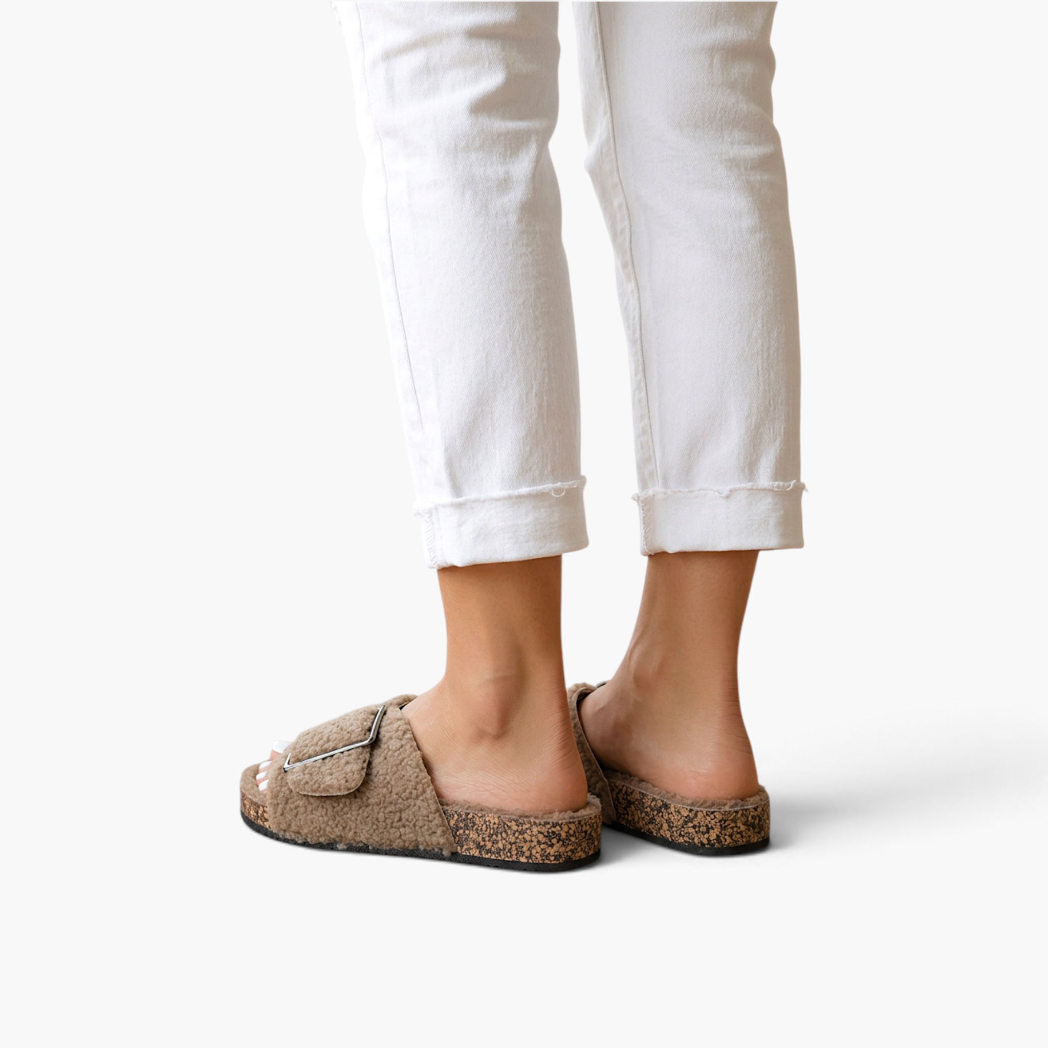 Beach Rose Co. Rochelle beige vegan suede sherpa slippers with a metal buckle and cork-style sole on a model