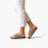 Beach Rose Co. Rochelle beige vegan suede sherpa slippers with crossed bands and a metal buckle on a model