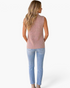 Beach Rose Co. beige sleeveless ribbed turtleneck sweater worn by a woman with long blonde hair, back view