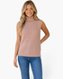 Beach Rose Co. beige sleeveless ribbed knit turtleneck sweater worn by a smiling blonde woman with blue jeans