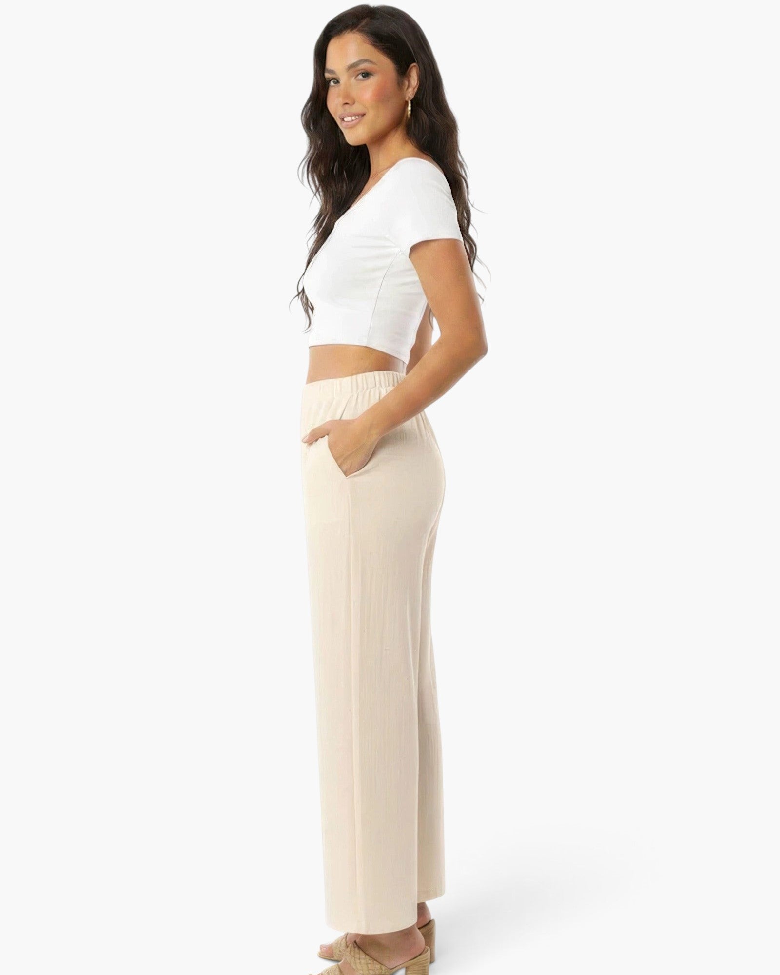 Beach Rose Co. relaxed fit beige wide-leg cotton pants with side pockets worn by a woman in a white crop top