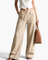 Beach Rose Co. beige wide-leg cotton blend pants featuring oversized front flap pockets and a flat front waistband.