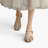 Beach Rose Co. beige PU leather T-bar flat sandals with an interwoven caged strap design and adjustable buckle.
