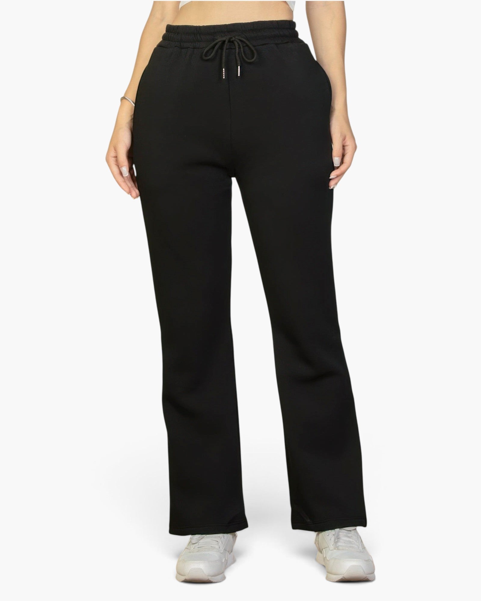 Beach Rose Co. black bootcut sweatpants with a drawstring waist and slant pockets worn by a woman