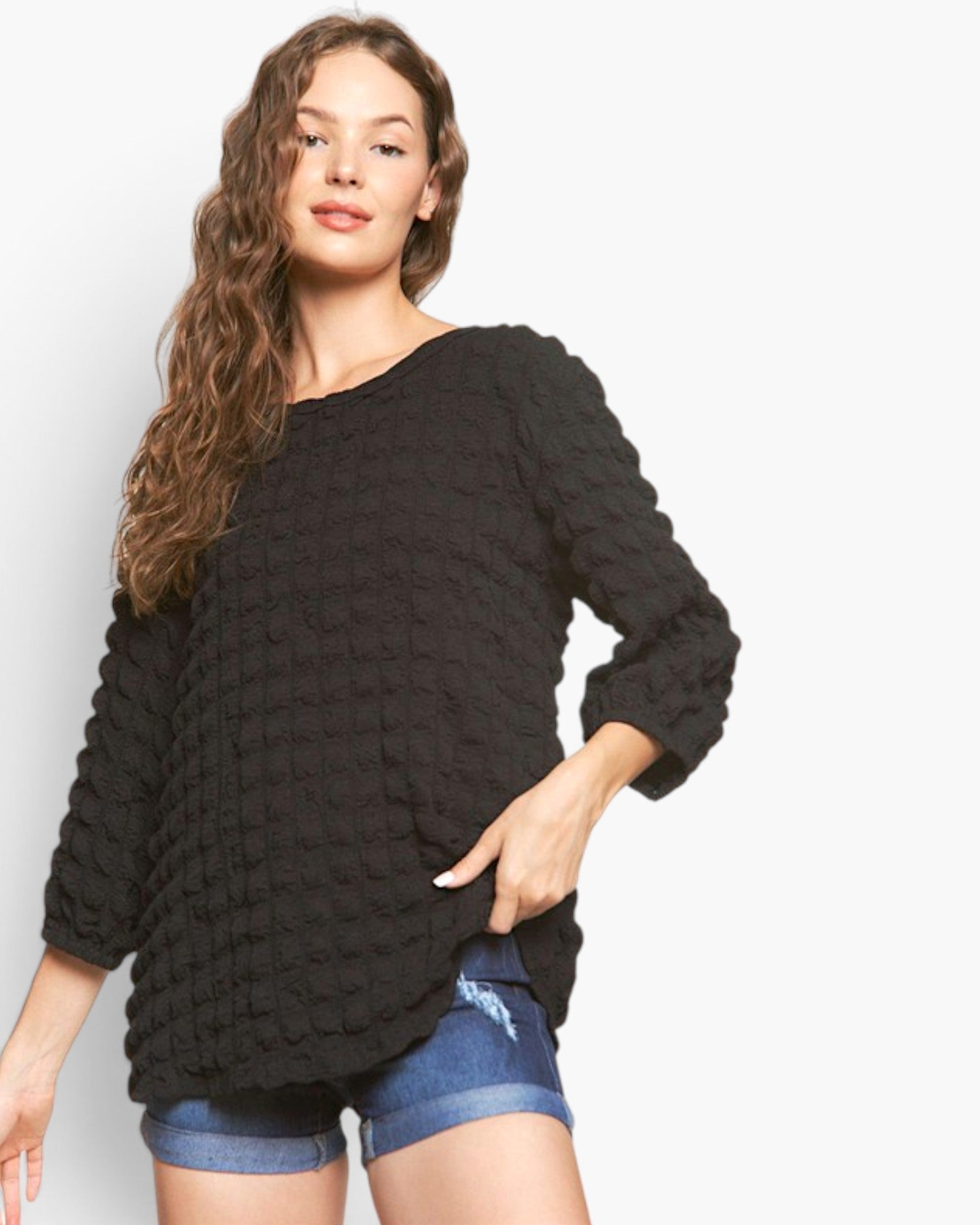 Beach Rose Co. black bubble knit long sleeve top with a round neckline and relaxed fit worn by a model.