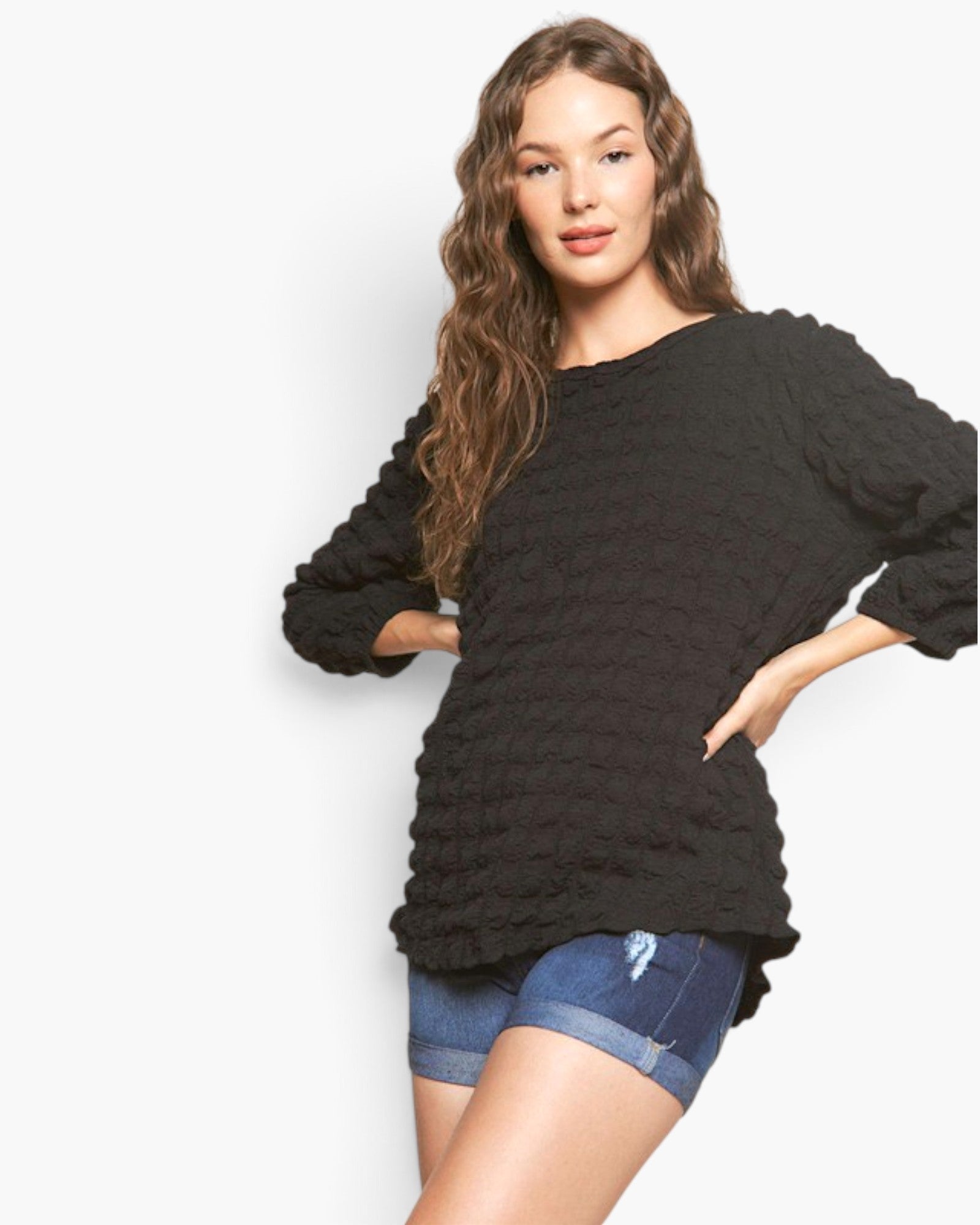 Beach Rose Co. black bubble knit long sleeve top with a round neckline and relaxed fit worn by a model.
