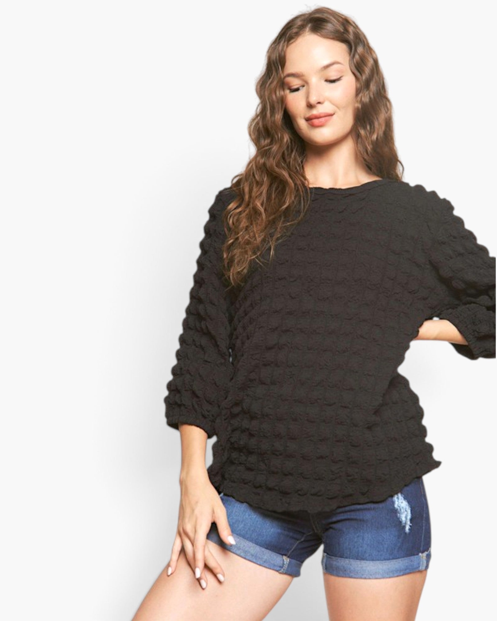Beach Rose Co. black long sleeve top with bubble knit texture, round neckline, and relaxed fit on a female model.