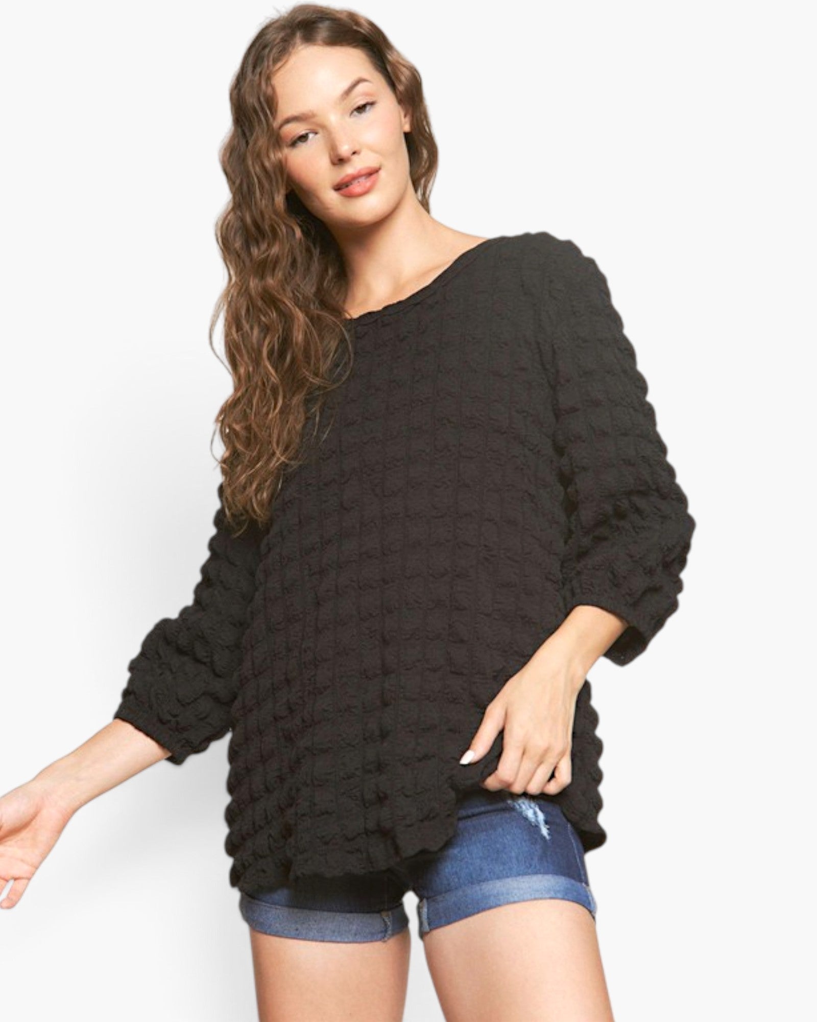 Beach Rose Co. black bubble knit long sleeve top with a round neckline and relaxed fit worn by a model