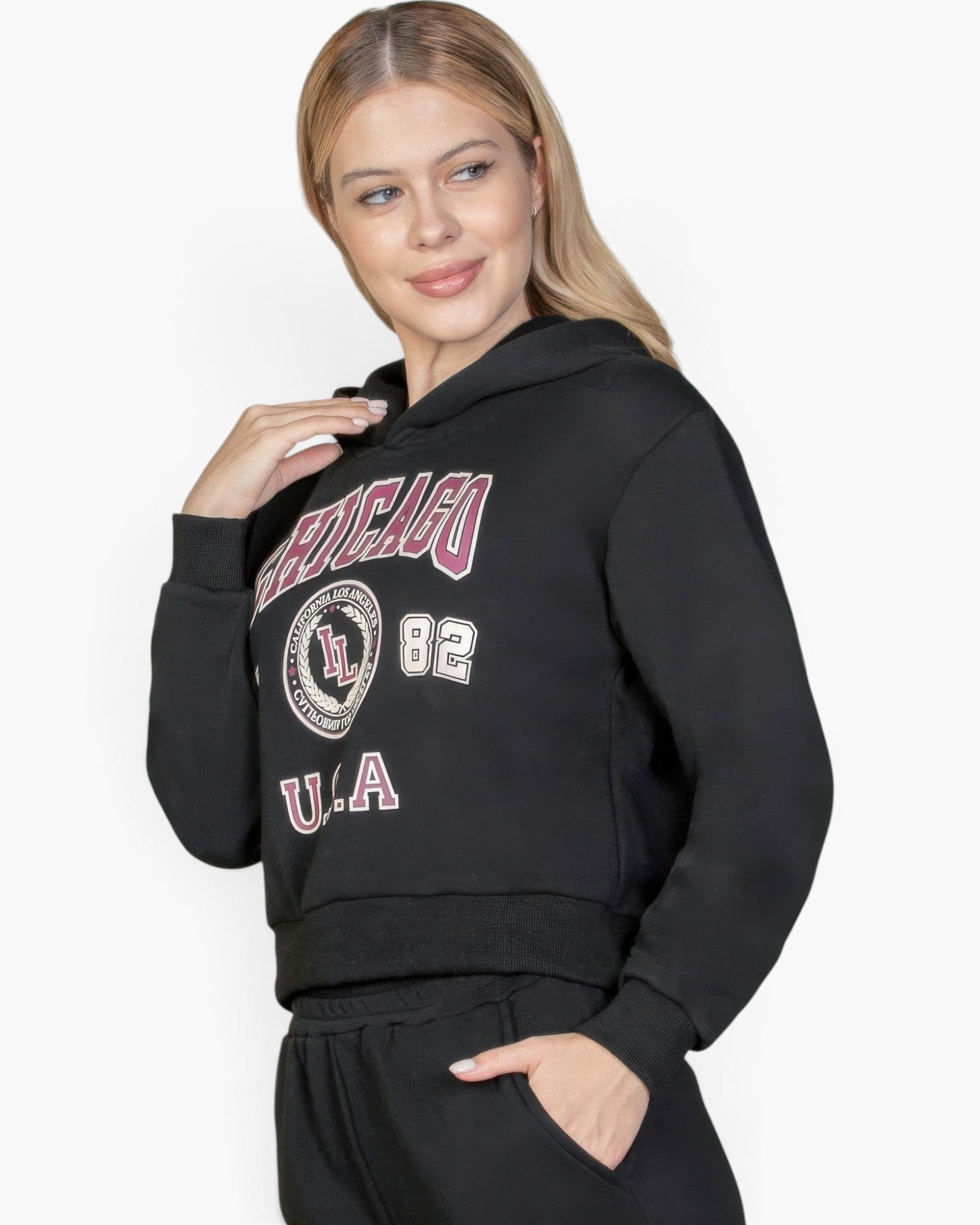 Beach Rose Co. black drop shoulder pullover hoodie with Chicago graphic print worn by a blonde woman