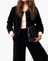 Beach Rose Co. black corduroy two-piece set featuring a button-front jacket and wide leg pants worn with a mock neck.