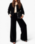 Beach Rose Co. black corduroy two-piece set with a button-front jacket and wide-leg pants worn by a model.