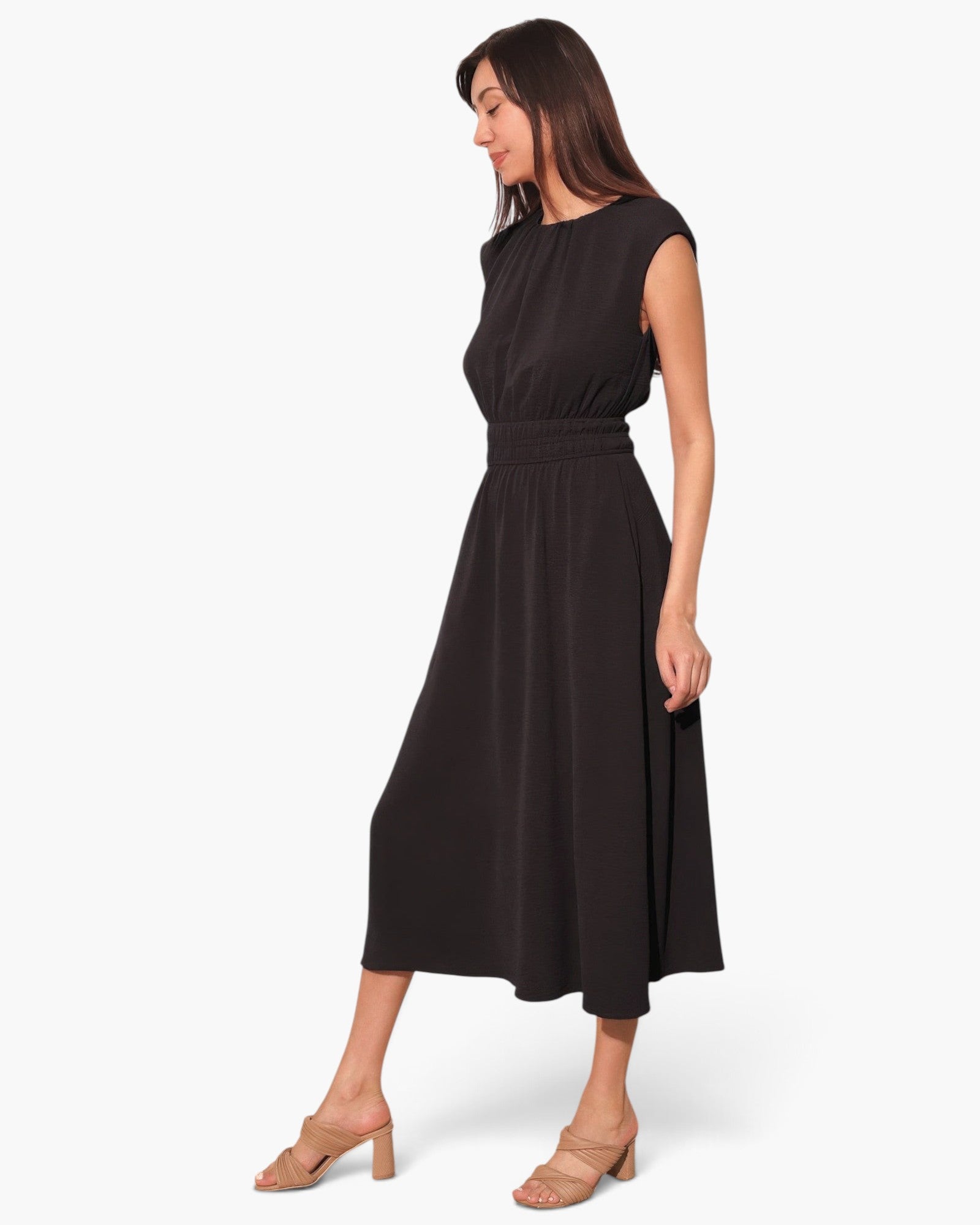 Beach Rose Co. black matte crepe midi dress with ruched elastic waist and pockets worn by a model