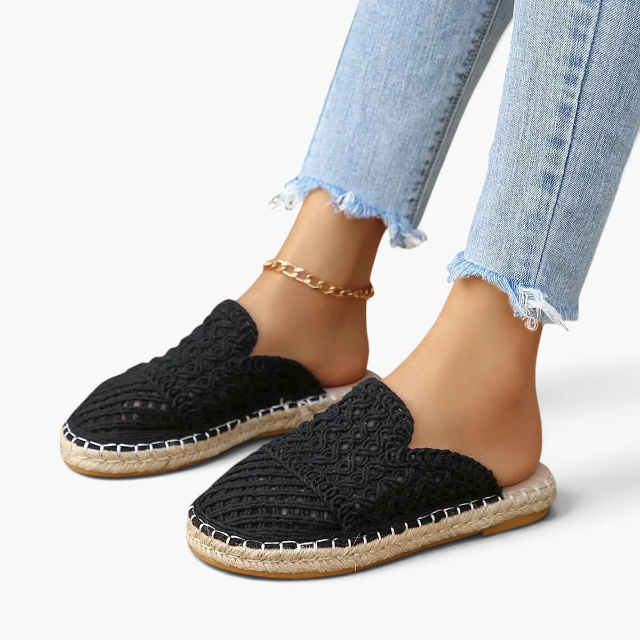 Beach Rose Co. black crochet-style mesh espadrille mules with braided sole trim worn with light wash jeans.