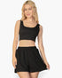 Beach Rose Co. black crop tank top and elastic waist shorts set in textured 4-way stretch fabric on a blonde model