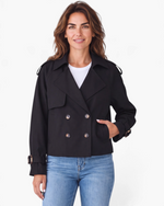 Beach Rose Co. black cropped double-breasted trench jacket with wide lapels and buckled cuffs worn by a woman