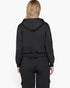 Beach Rose Co. black drop shoulder pullover hoodie worn by a blonde woman, back view showing relaxed fit.