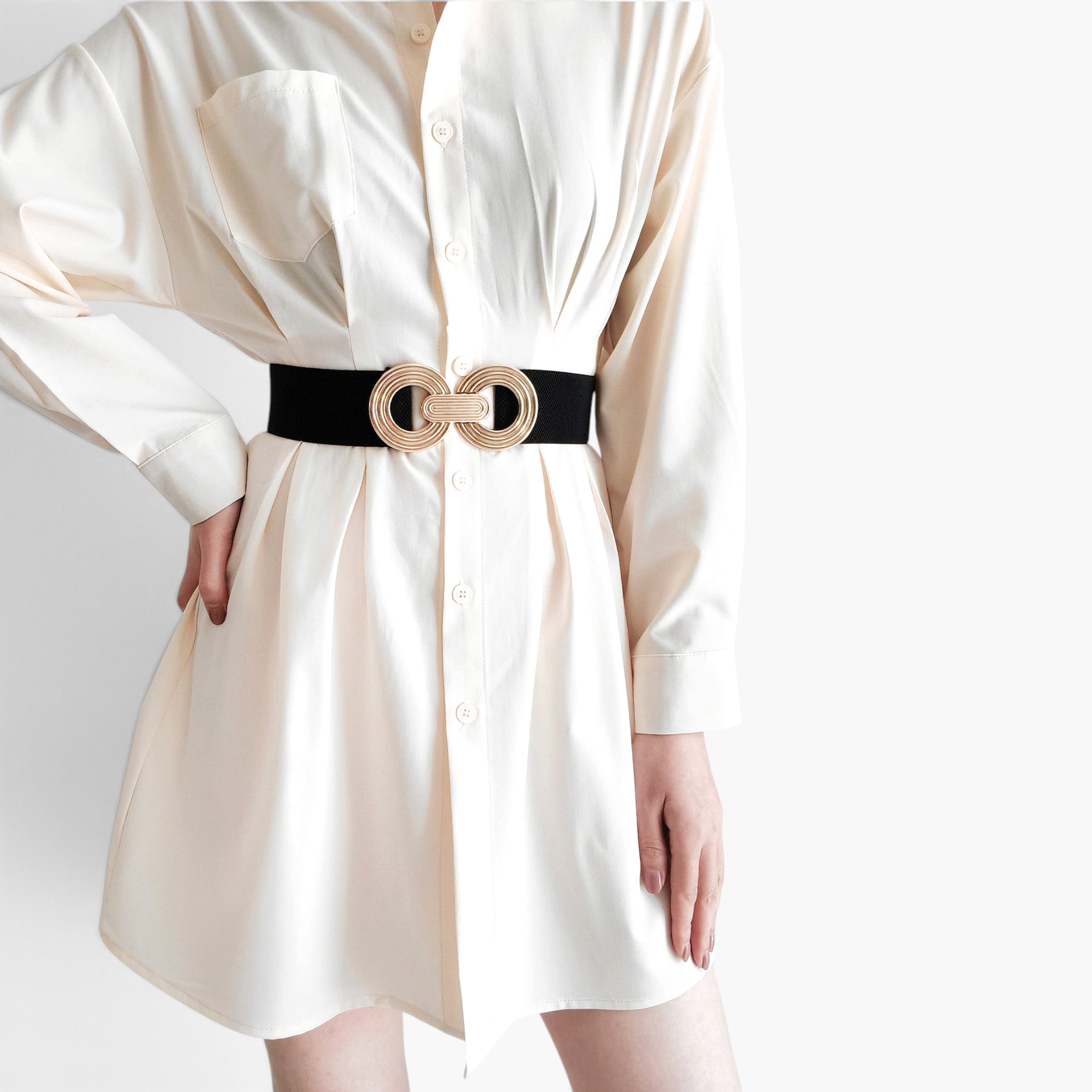 Beach Rose Co. wide black elastic waist belt with a gold double-circle alloy buckle worn over a cream shirt dress.