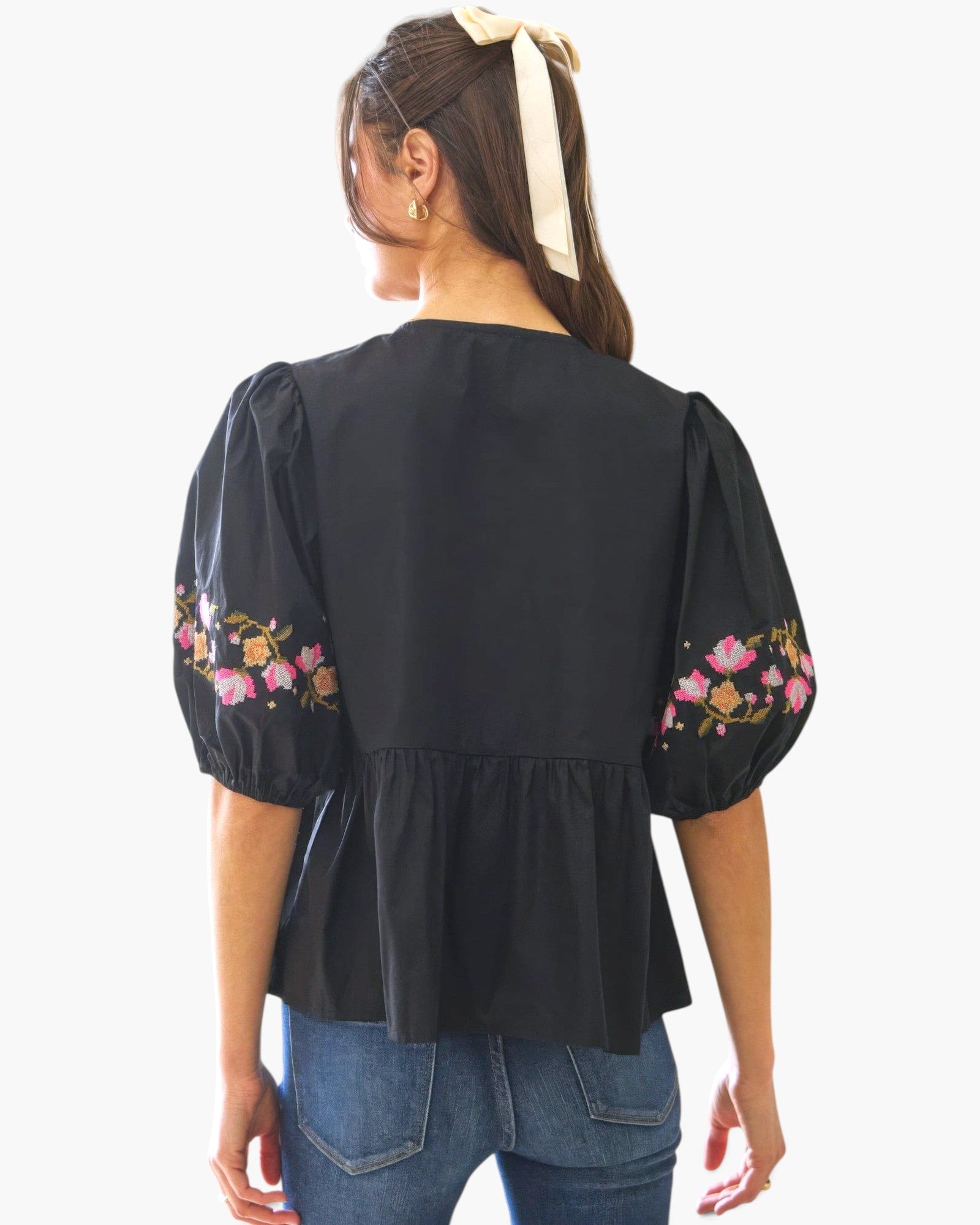 Beach Rose Co. black poplin blouse with puff sleeves, floral embroidery, and a back view of a model with a hair ribbon