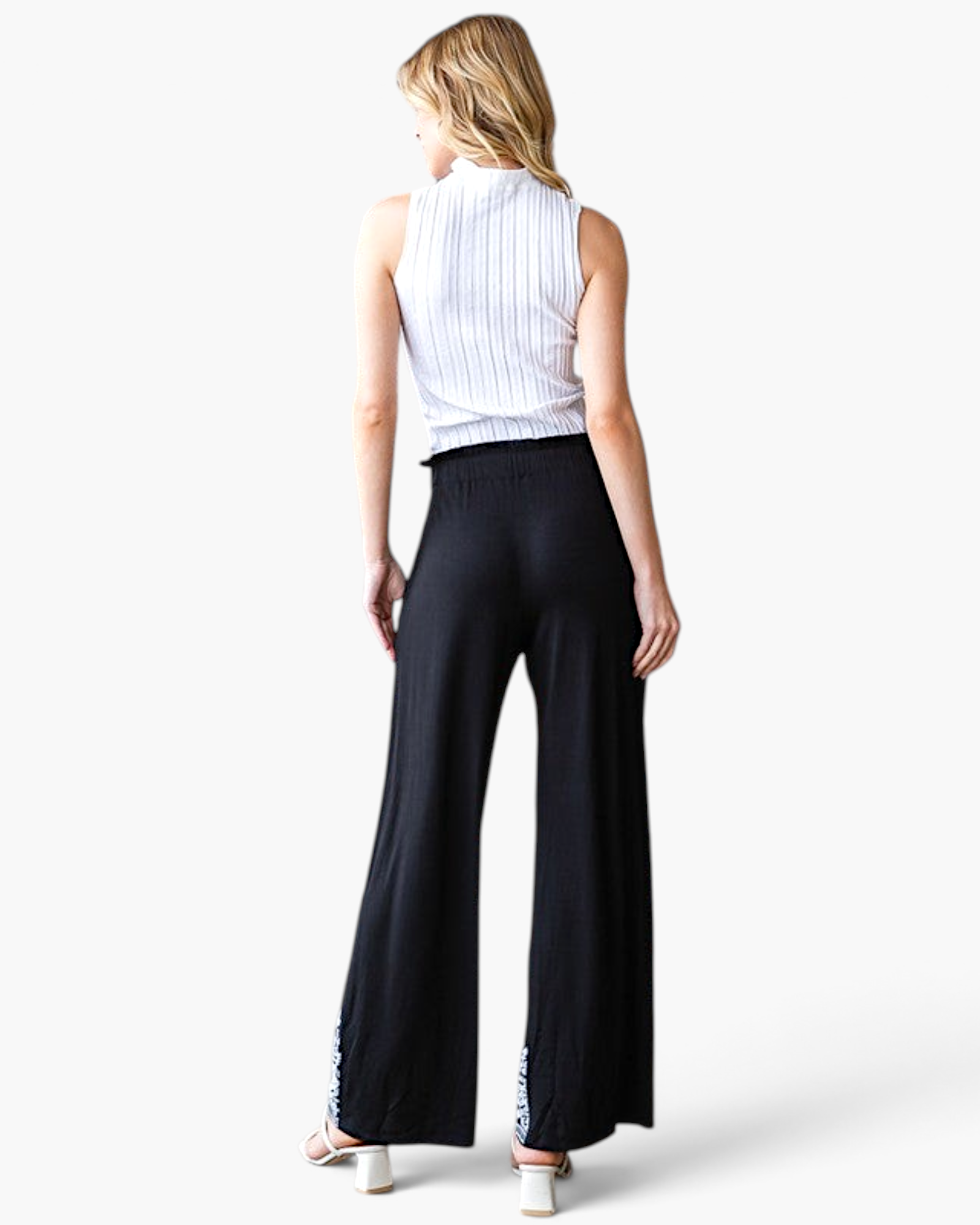 Beach Rose Co. black wide-leg pants with white embroidered hem worn by a woman from the back view