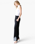 Beach Rose Co. black wide-leg pants with white embroidered hem, elastic waistband, and side pockets on a model