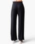 Beach Rose Co. black wide-leg pants with white embroidered hem detail and elastic waistband, back view