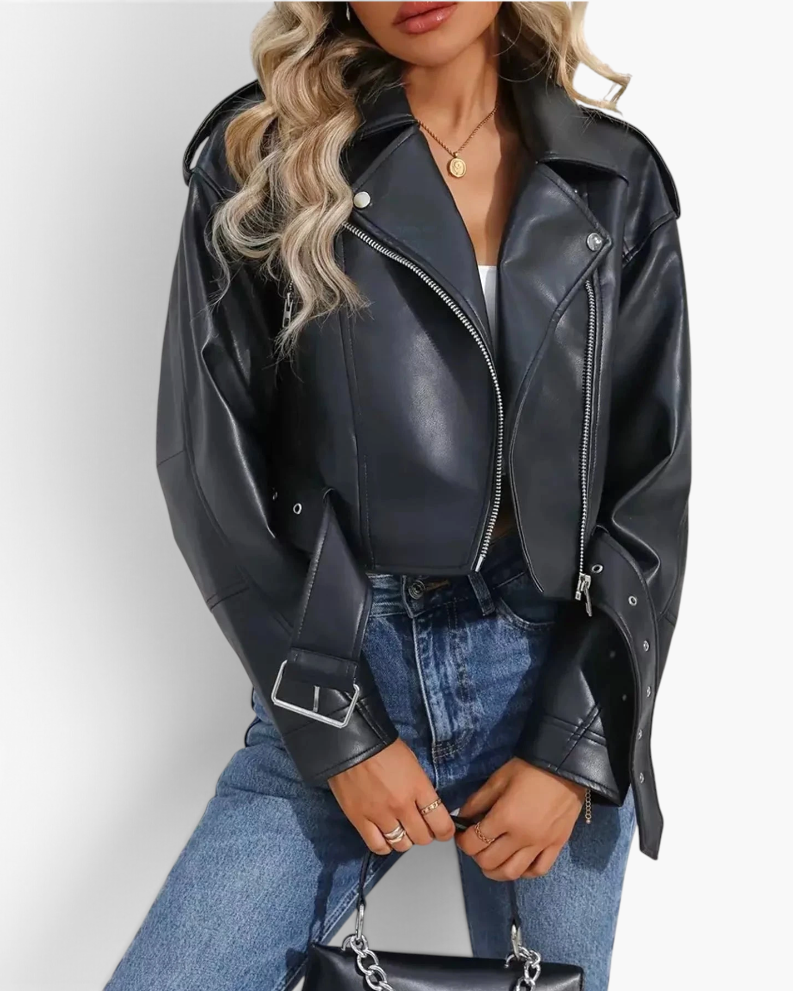 Beach Rose Co. black faux leather cropped moto jacket with asymmetrical zipper, shoulder epaulets, and grommet belt.