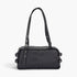 Beach Rose Co. black faux leather sport bag with dual handles, silver metal hardware, and side buckle details.