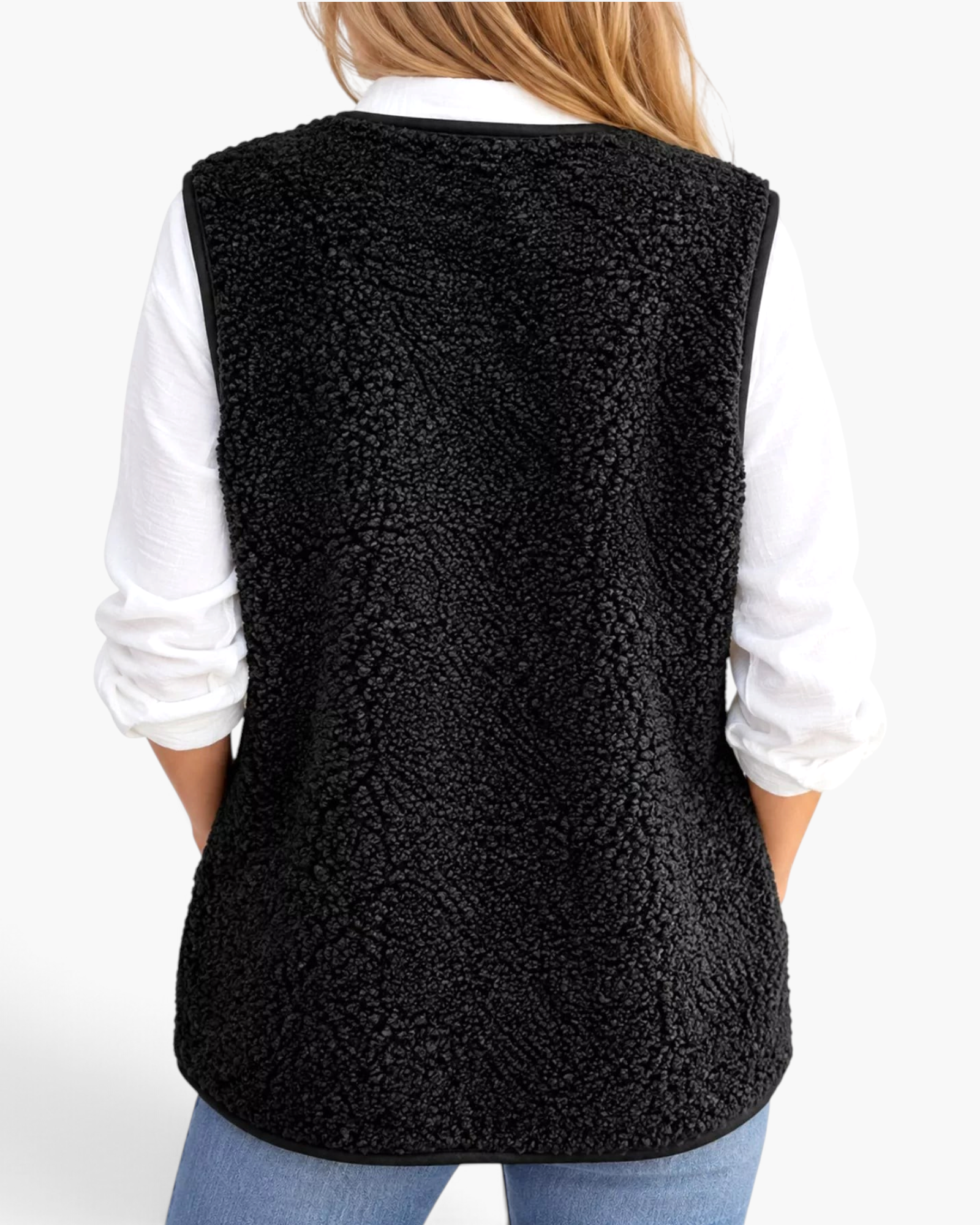 Beach Rose Co. black polar fleece vest with bound edges worn over a white shirt, back view