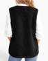 Beach Rose Co. black polar fleece vest with bound edges worn over a white shirt, back view