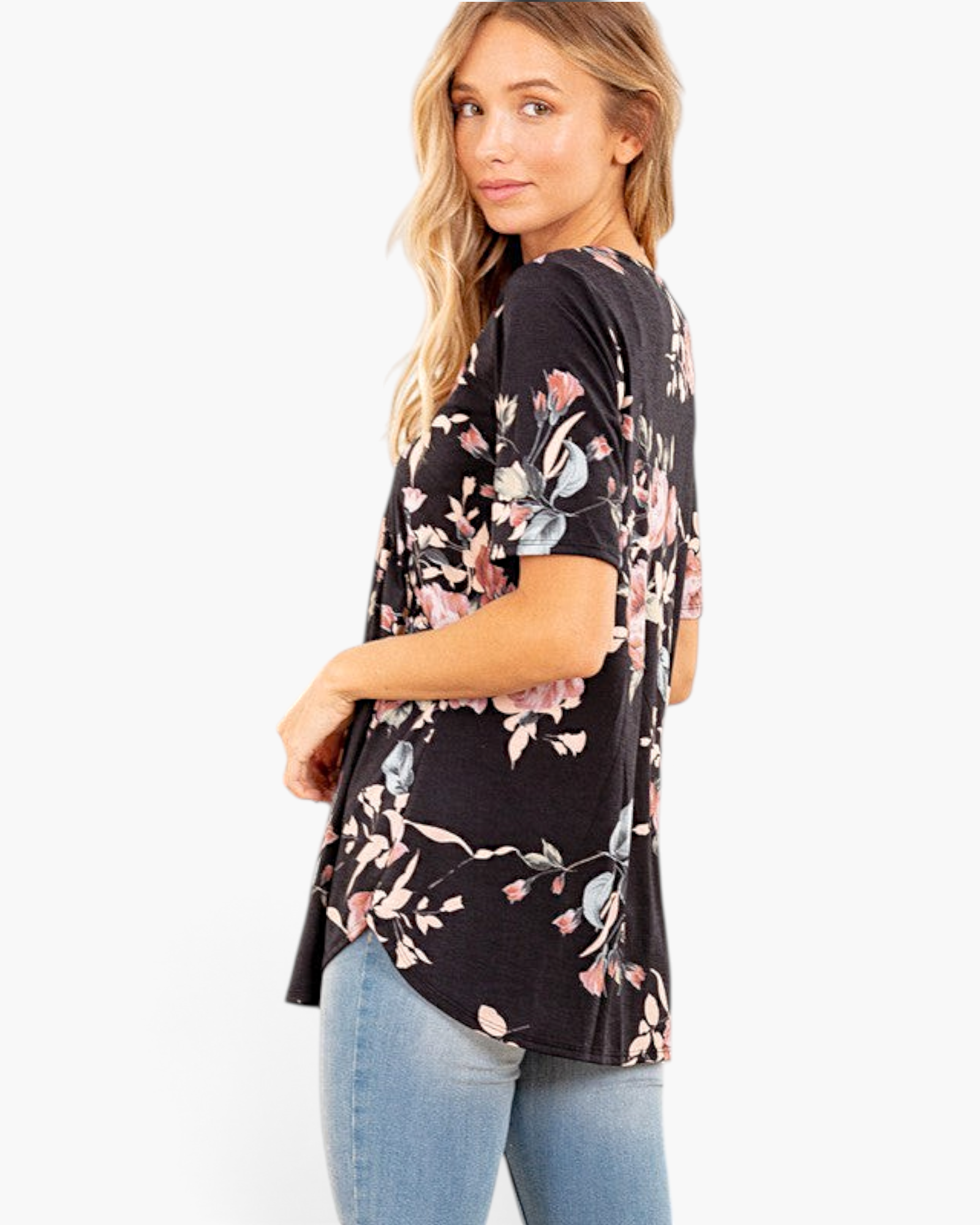 Beach Rose Co. black floral babydoll top with short sleeves and a curved hem worn by a model in profile view.