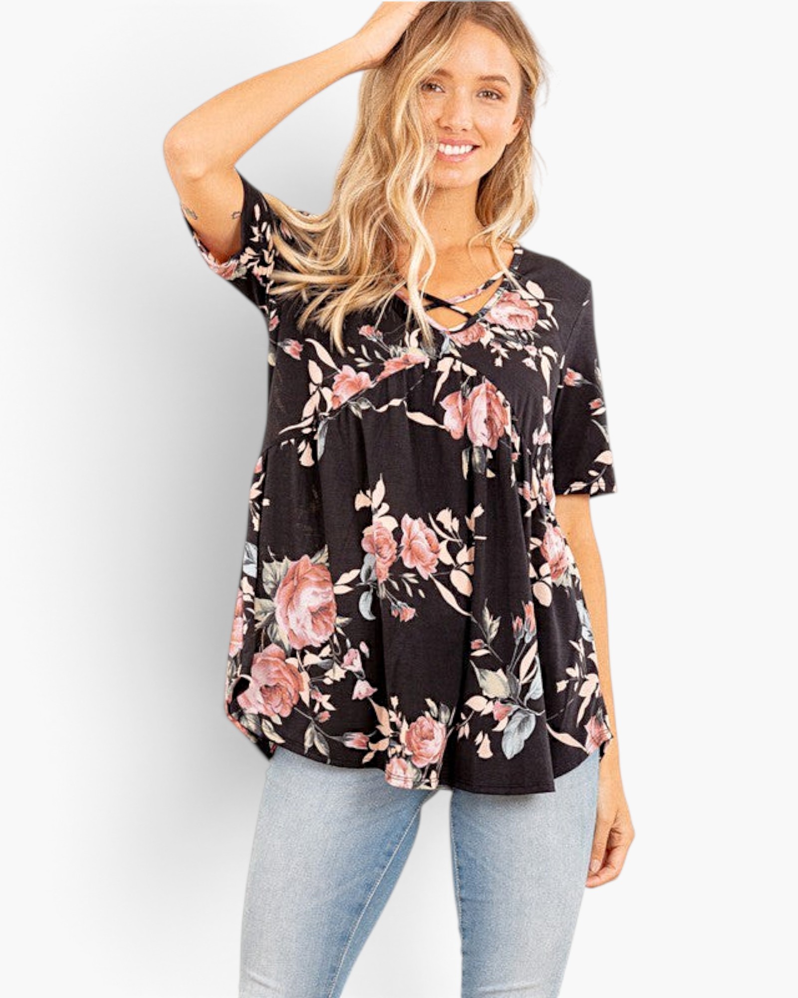 Beach Rose Co. black floral babydoll top with a crisscross V-neckline and short sleeves on a smiling model