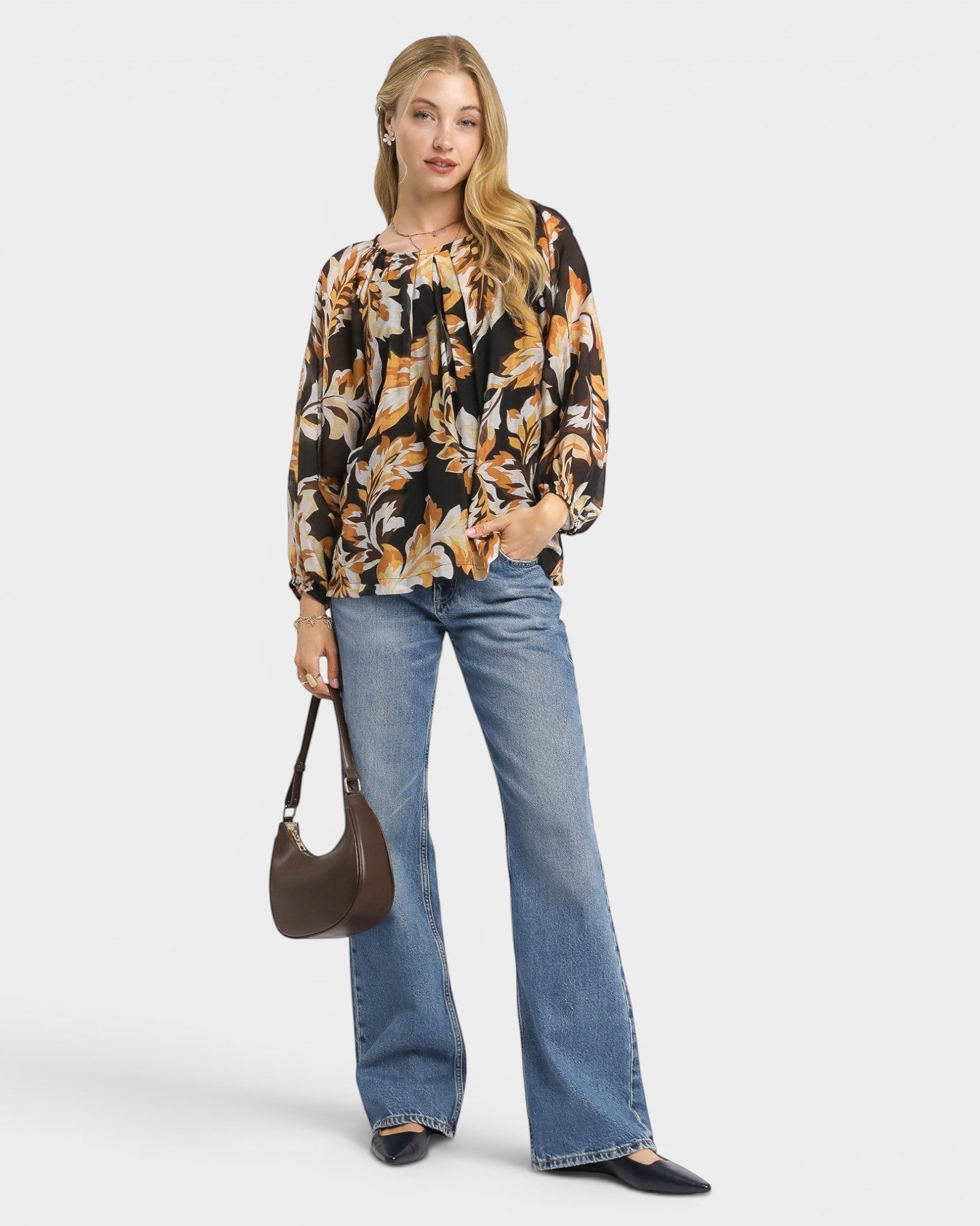 Beach Rose Co. black floral print blouse with gathered neckline, billowy sleeves, and elastic cuffs. Made of rayon and nylon.