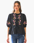 Beach Rose Co. black poplin blouse with pink floral embroidery and front ribbon ties worn by a model